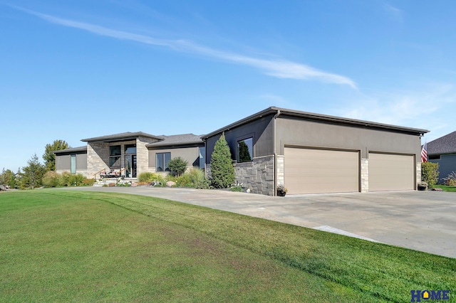 view of front of house with a front yard and a garage