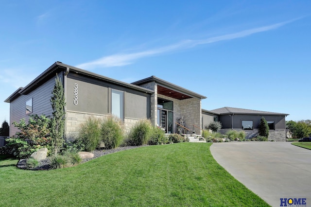 contemporary home featuring a front lawn