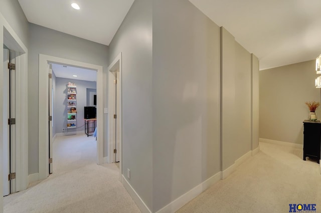 corridor featuring light colored carpet