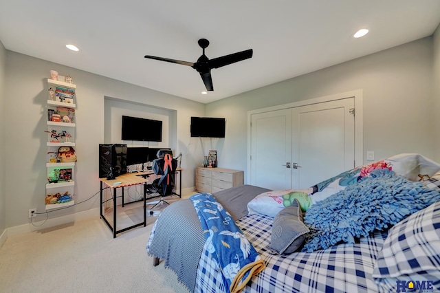 bedroom featuring a closet, ceiling fan, and light carpet