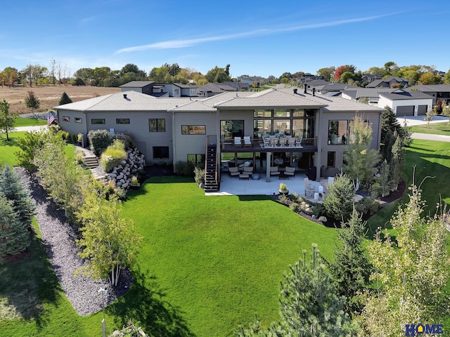 rear view of property with a patio and a yard