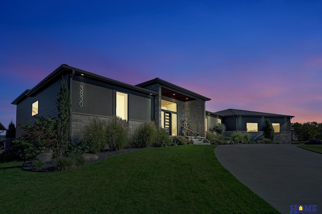 contemporary home with a lawn