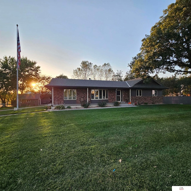 ranch-style house featuring a yard