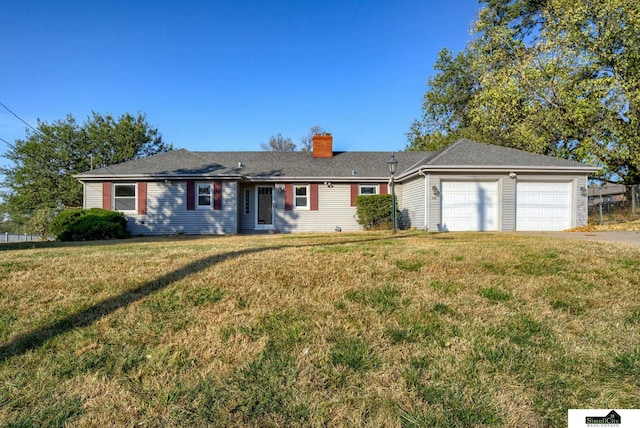 single story home with a front yard and a garage