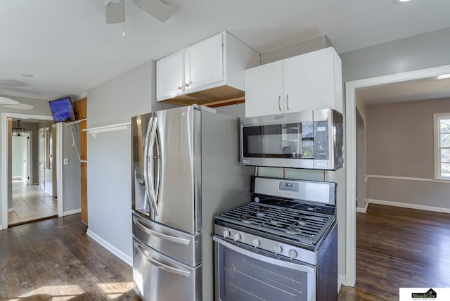 kitchen with dark wood-type flooring, white cabinets, stainless steel appliances, and ceiling fan