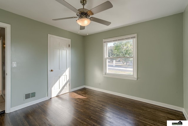 unfurnished bedroom featuring dark wood-type flooring and ceiling fan