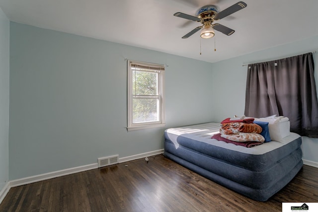 bedroom with ceiling fan and dark hardwood / wood-style flooring