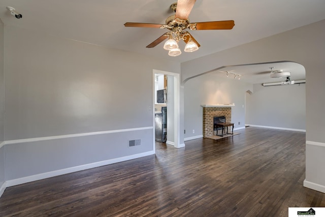 unfurnished living room featuring dark hardwood / wood-style floors and ceiling fan