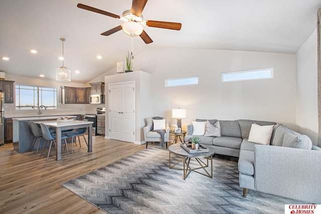 living room featuring ceiling fan, high vaulted ceiling, and dark hardwood / wood-style floors