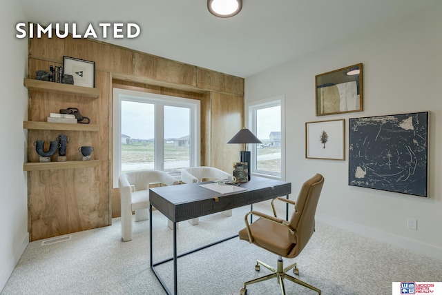 office area with wooden walls and light colored carpet