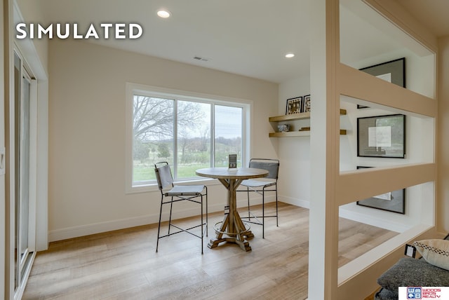 dining space with light hardwood / wood-style flooring