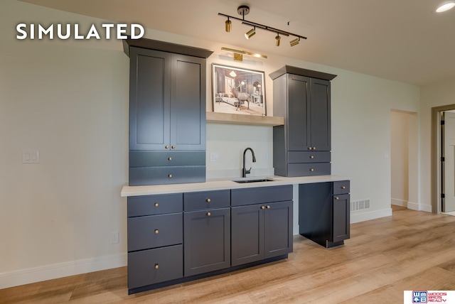 kitchen featuring sink and light wood-type flooring