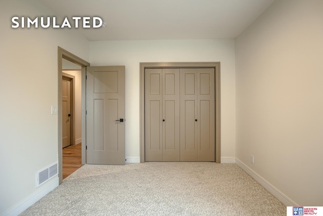 unfurnished bedroom with carpet flooring and a closet