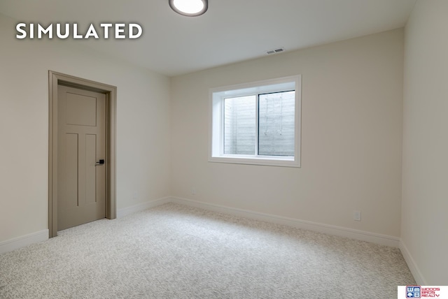 unfurnished room with light colored carpet