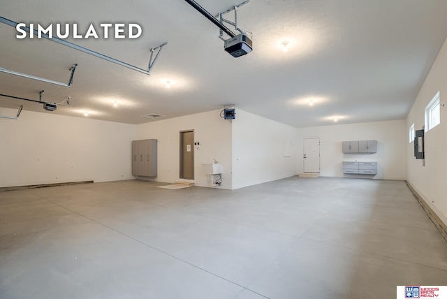 garage featuring a garage door opener and electric panel