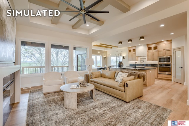 living room featuring light hardwood / wood-style flooring, sink, plenty of natural light, and ceiling fan