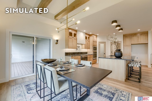 kitchen featuring a center island, decorative light fixtures, light brown cabinetry, premium range hood, and light hardwood / wood-style floors