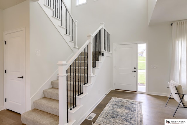 foyer featuring dark hardwood / wood-style flooring and a high ceiling