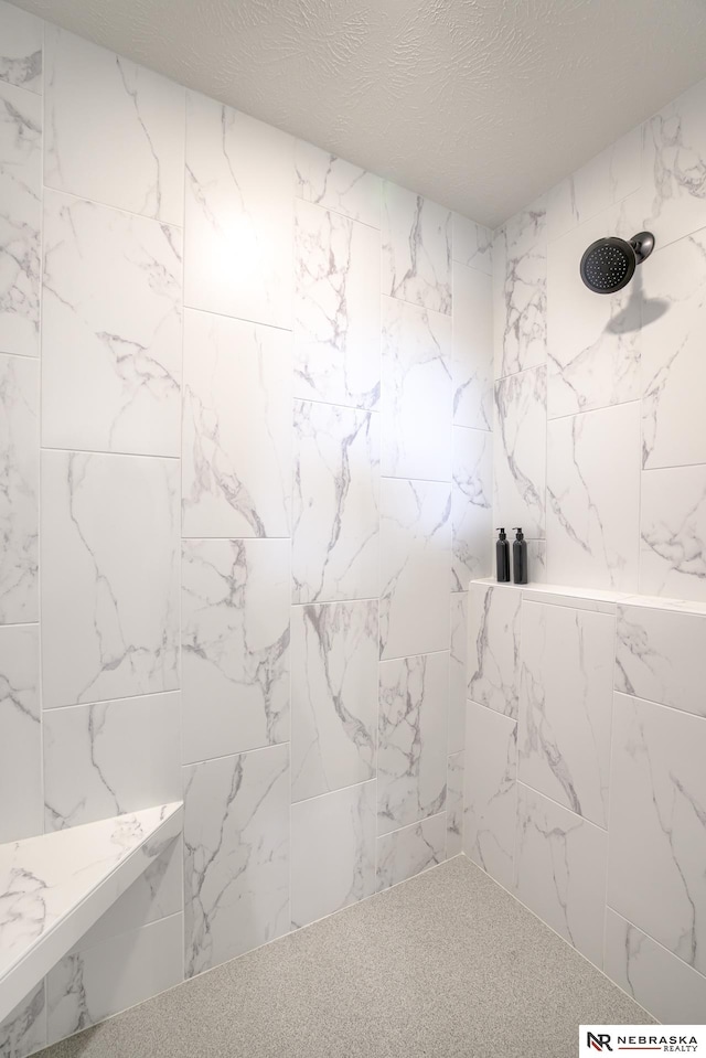 bathroom with a tile shower