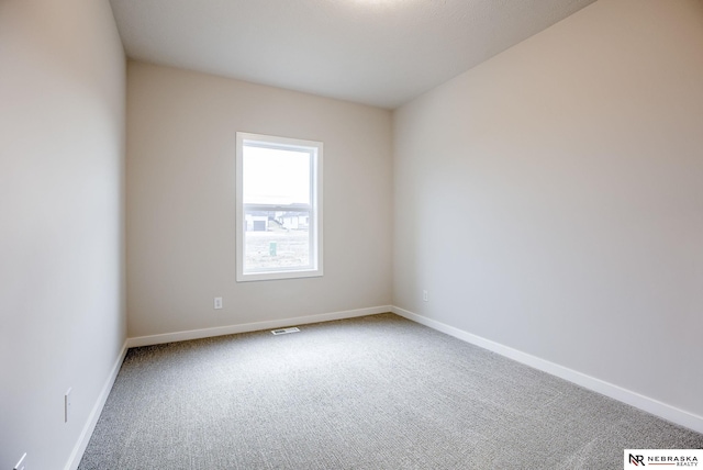 spare room featuring carpet