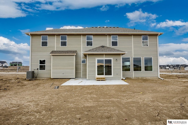 back of property with central AC unit and a patio area