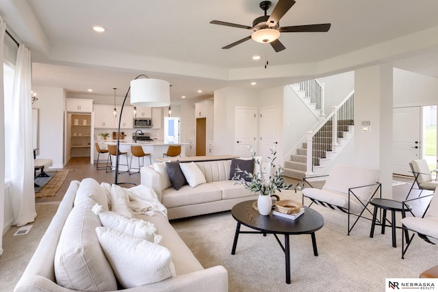 living room featuring ceiling fan and light hardwood / wood-style flooring