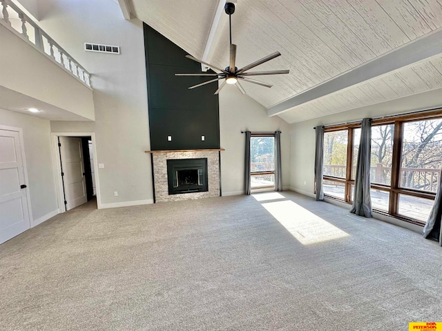 unfurnished living room with ceiling fan, high vaulted ceiling, beam ceiling, and plenty of natural light