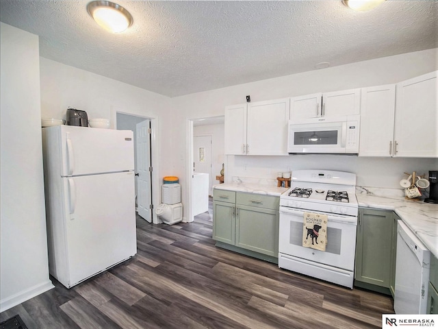 kitchen with green cabinets, dark wood-type flooring, a textured ceiling, and white appliances