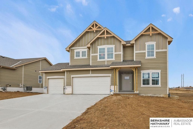 craftsman house featuring a garage and central AC unit