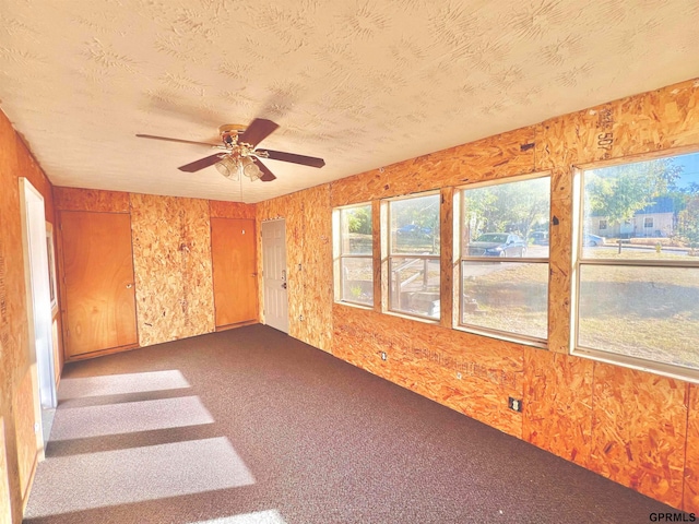 spare room featuring carpet floors and ceiling fan