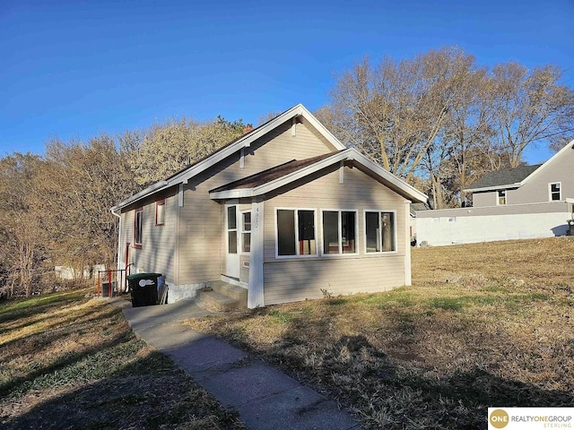 view of property exterior featuring a lawn