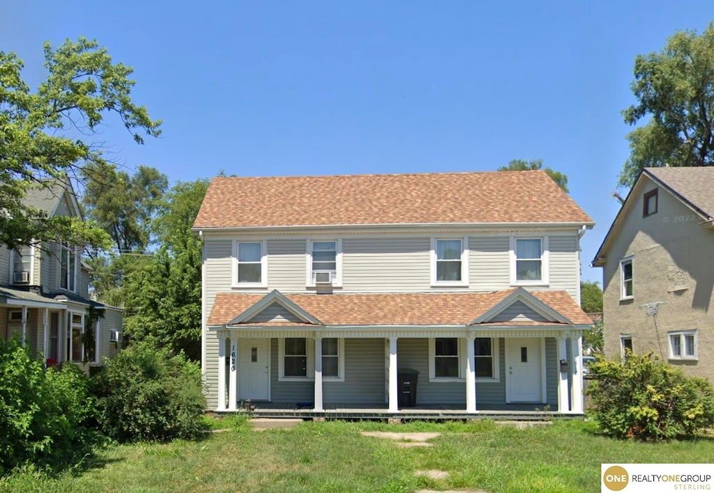 view of front of property with a porch and a front yard