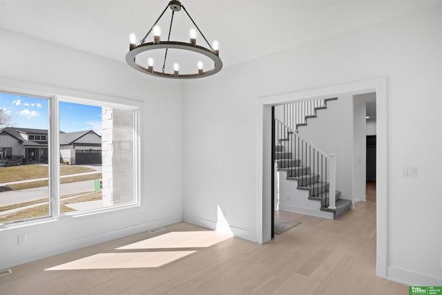 interior space featuring a notable chandelier and light hardwood / wood-style floors