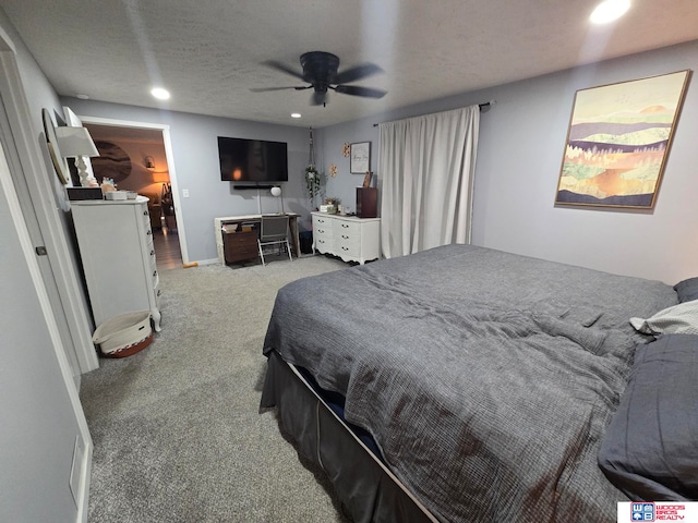 carpeted bedroom with a textured ceiling and ceiling fan