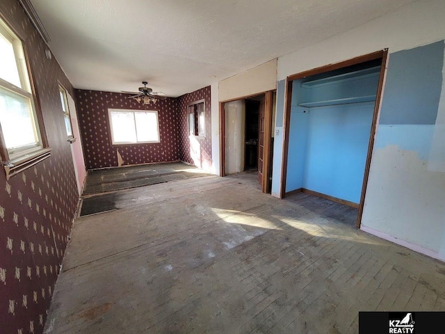 unfurnished bedroom with a textured ceiling and a closet