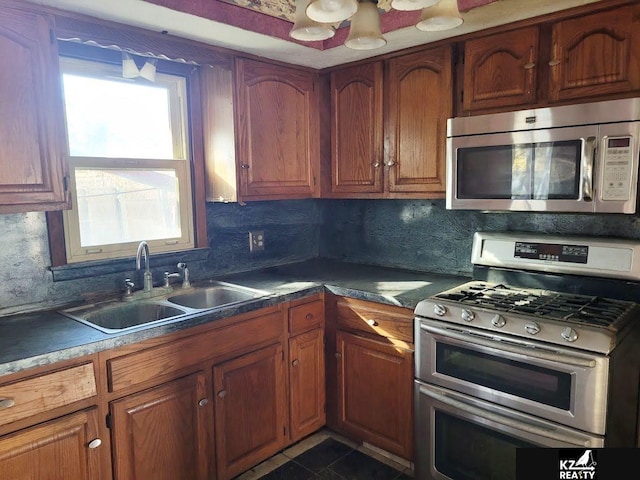 kitchen with decorative backsplash, stainless steel appliances, and sink