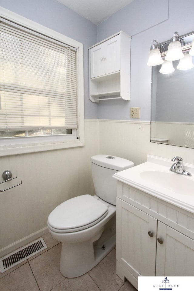 bathroom featuring vanity, toilet, and tile patterned floors