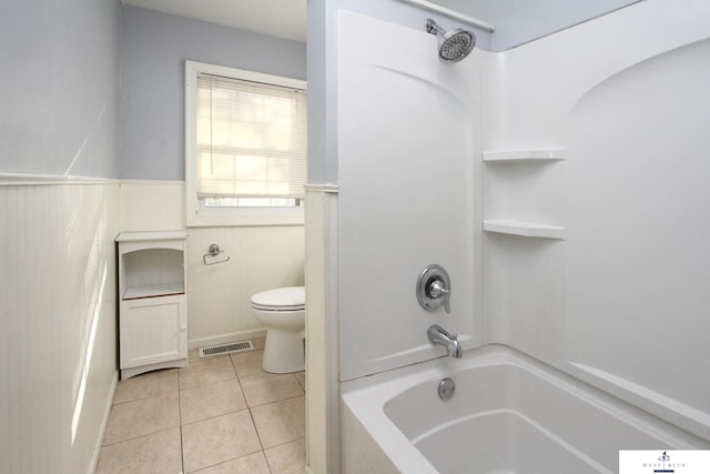 bathroom featuring toilet, tile patterned floors, and washtub / shower combination