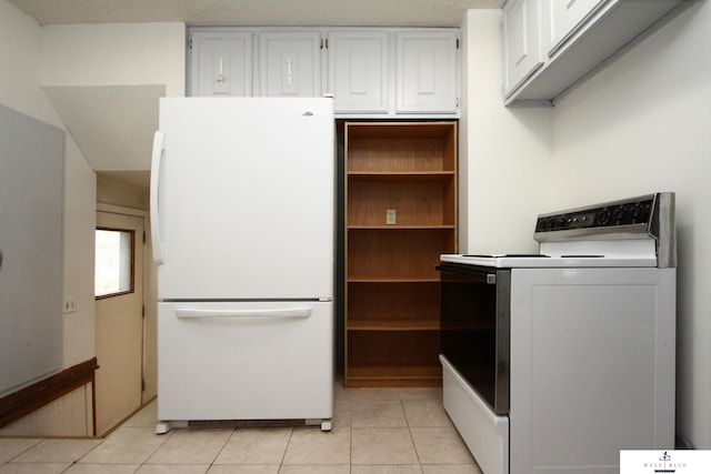 kitchen with light tile patterned floors, white cabinetry, a textured ceiling, range, and white refrigerator