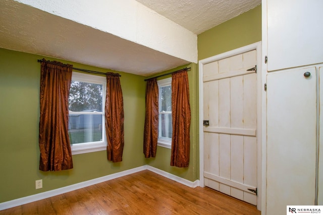 interior space featuring light hardwood / wood-style flooring and a textured ceiling