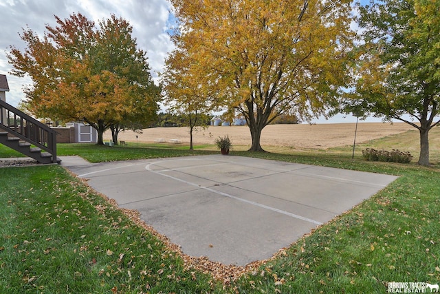 view of basketball court featuring a lawn