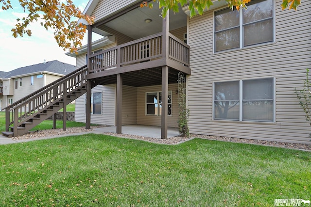 rear view of property featuring a patio area and a lawn