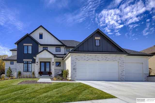 view of front of house with french doors, a garage, and a front lawn