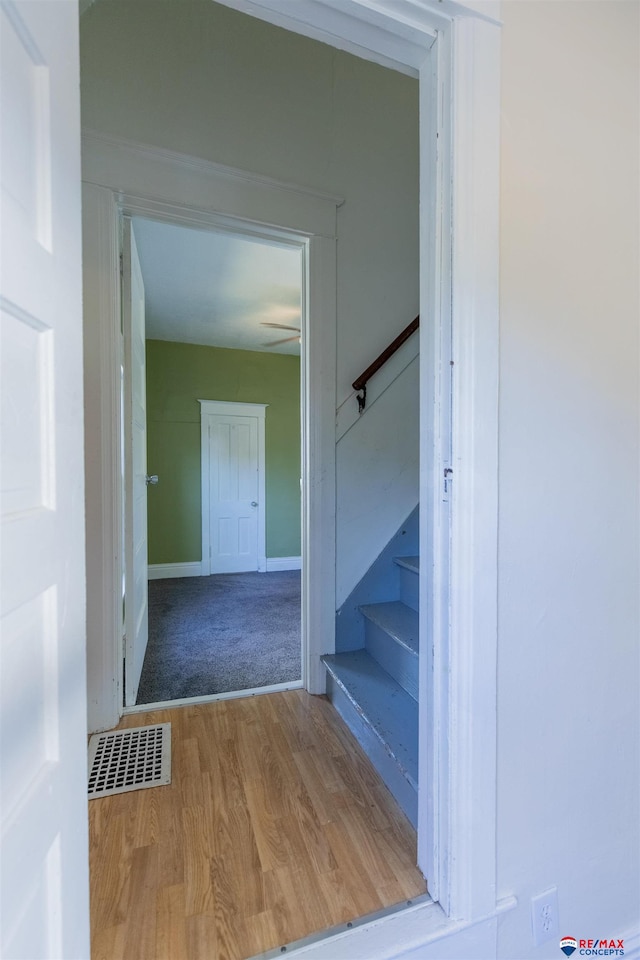 stairs featuring wood-type flooring