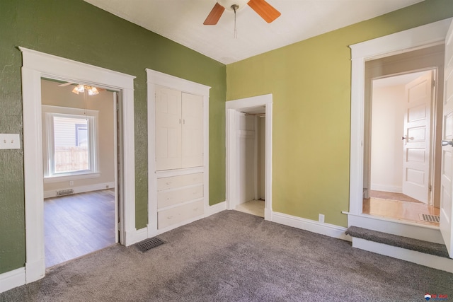 unfurnished bedroom featuring ceiling fan and carpet