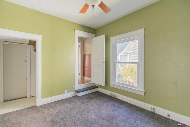 unfurnished bedroom featuring ceiling fan and carpet flooring