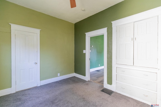 unfurnished bedroom with light colored carpet, a closet, and ceiling fan