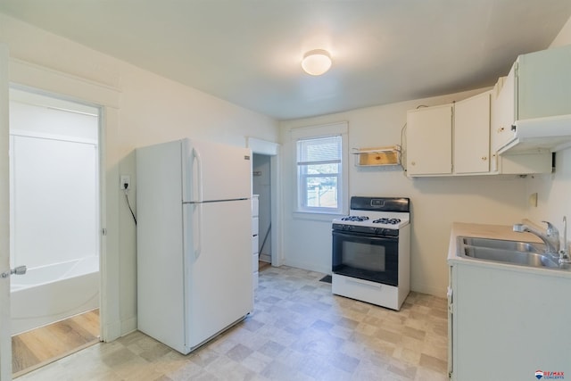 kitchen with white appliances, white cabinetry, and sink