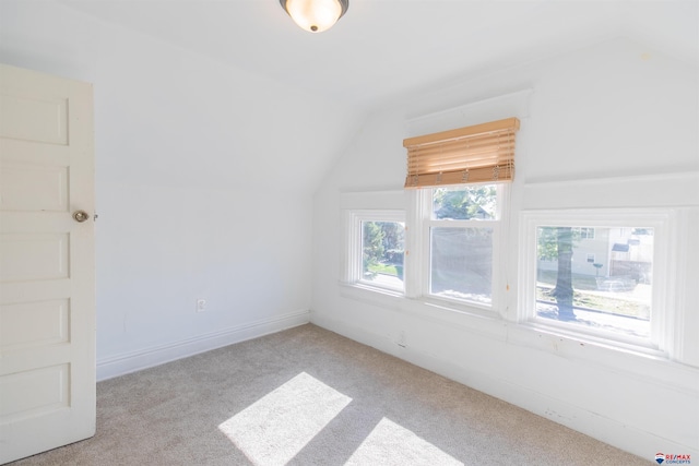 bonus room featuring light carpet and lofted ceiling