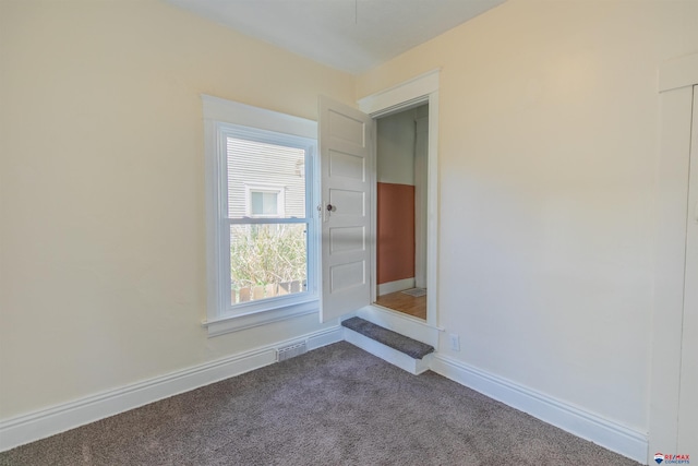 unfurnished room with carpet flooring